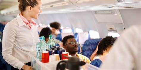flight attendant adjusting meal service in cramped Airbus galley