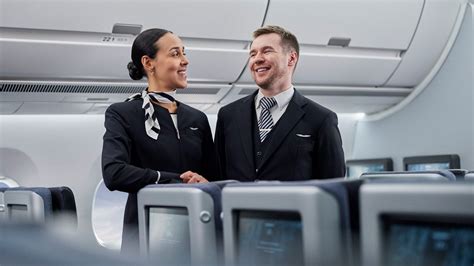 flight attendant handing sanitizing wipes to passengers during aircraft boarding