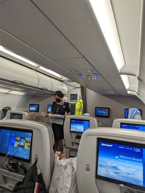 flight attendant inspecting soda cans before cabin service