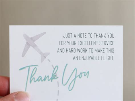 flight attendant receiving thank you note and chocolates from passenger