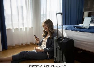 flight attendant relaxing in hotel room with carry-on comfort items