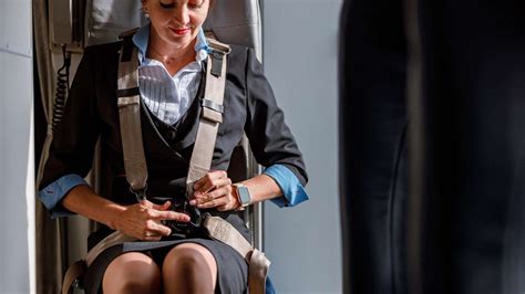 flight attendants seated in jumpseats preparing for aircraft landing
