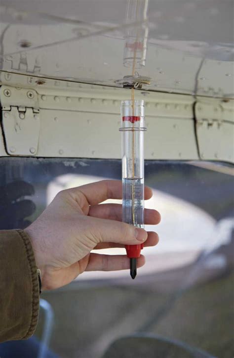 flight instructor demonstrating GATS jar fuel testing process at small GA airport