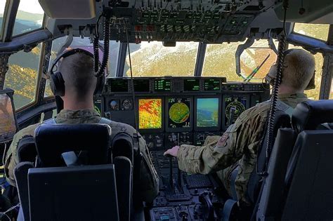 fog and low clouds obscuring mountainous terrain from pilot cockpit