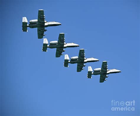 Formation of A-10 Warthogs flying low over mountainous terrain during training exercise