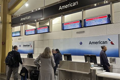 former Spirit Airlines travelers checking in at American Airlines counter