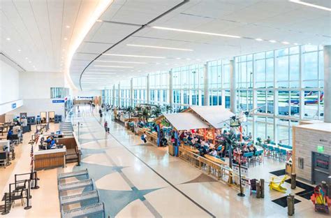 Fort Lauderdale airport terminal with multiple airline gates and passengers