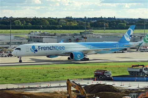 French bee A350-1000 at Paris Orly with boarding stairs and ground crew visible