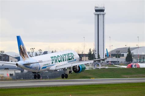 frontier airlines a320neo at seattle paine field gate with boeing factory in background