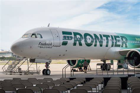 Frontier Airlines Airbus aircraft at airport gate with passenger service underway