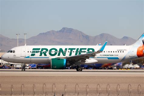 Frontier Airlines and Delta aircraft at ATL ramp as sunset casts orange glow over tarmac