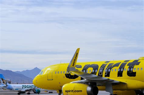 Frontier Airlines and Spirit Airlines aircraft at busy U.S. airport terminal