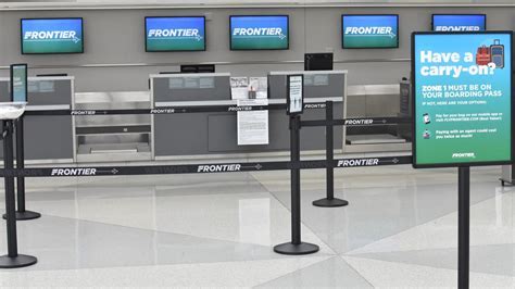 frontier airlines check-in counter with promotional $39 fare signage for baltimore to chicago route