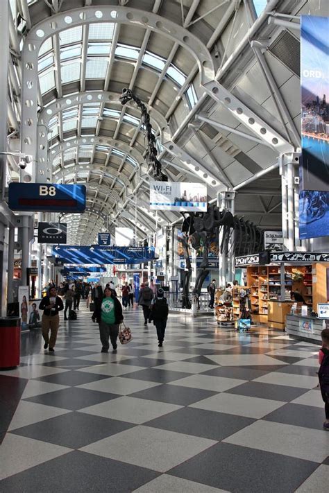 Frustrated passengers dealing with gate change announcements at Chicago O’Hare Terminal