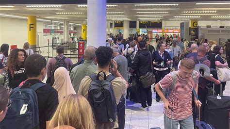frustrated Ryanair passengers queuing for customer service at Gatwick