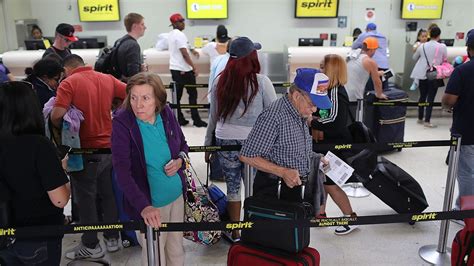 Frustrated Spirit Airlines passengers at Miami airport dealing with flight delays and rescheduling