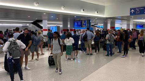 frustrated traveler filing baggage claim at American Airlines counter