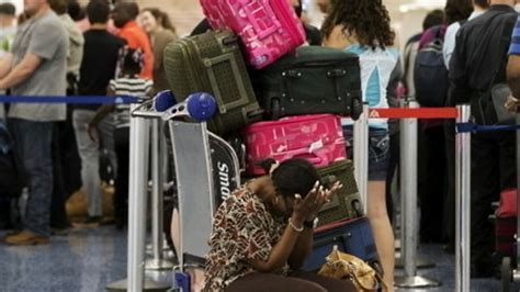 frustrated travelers queuing at mwanza airport for delayed precision air check-in