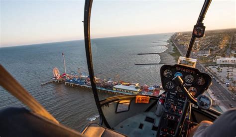 galveston helicopter mid-air with port and industrial backdrop