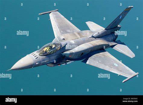 General Dynamics F-16 Fighting Falcon making a tight bank with external fuel tanks