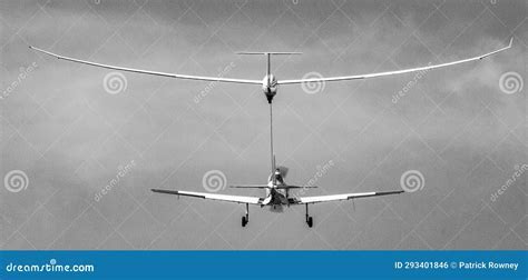 glider being launched by aerotow at mountain airfield