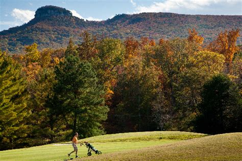 golf course at pilot knob park surrounded by mountains