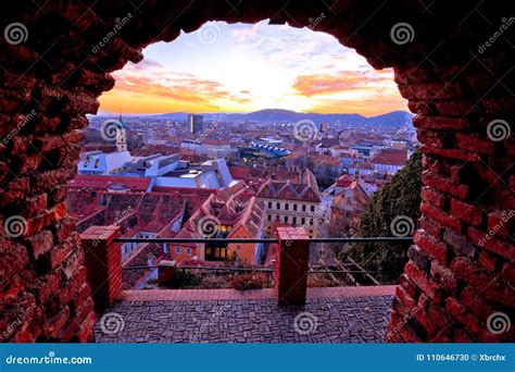 graz city center with schlossberg and mur river at sunset in winter