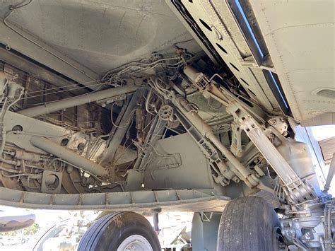 Ground crew inspecting B-52 outrigger gear before takeoff