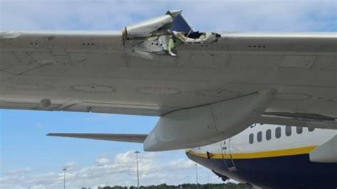 ground operations crew inspecting damaged Ryanair wing at Greek regional airport