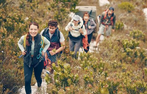 group of smiling onewheel riders on a forest trail during fall