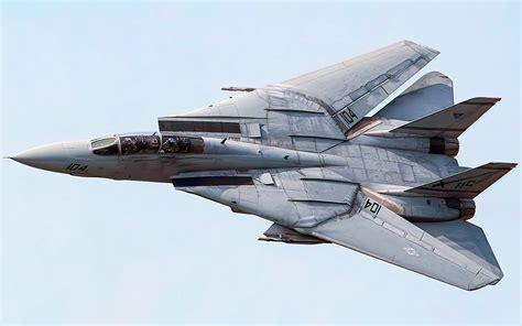 grumman f-14 tomcat in flight over mountainous terrain