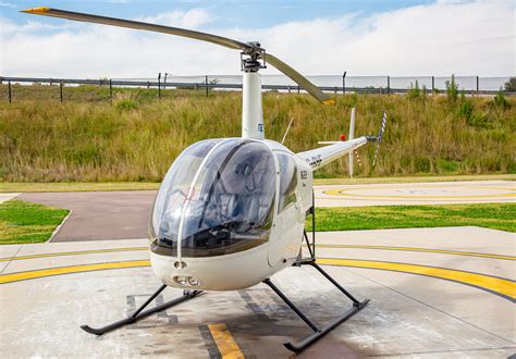 hangared Robinson R22 helicopter during pre-flight inspection