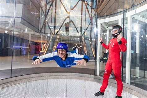 happy family posing with flight gear and certificates after indoor skydiving at iFLY Union City