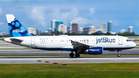 happy travelers exiting jetblue aircraft on sunny tropical tarmac