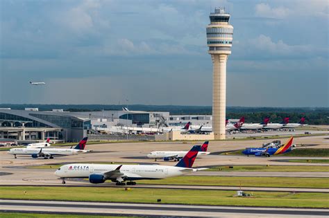 Hartsfield-Jackson Atlanta International Airport Delta aircraft lineup at busy terminal concourse