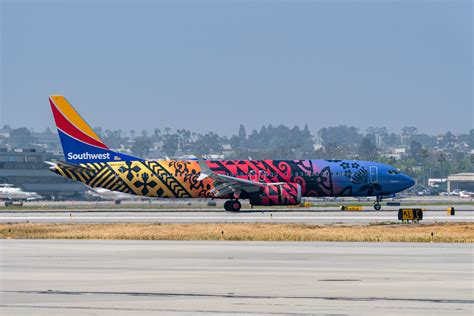 Hawaiian Airlines and Southwest aircraft parked side by side at Honolulu Airport