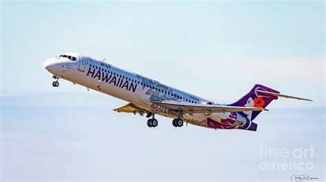 hawaiian airlines boeing 717 taking off from maui in sunrise