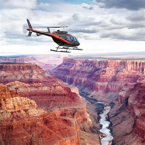 helicopter departing Grand Canyon station with train visible below