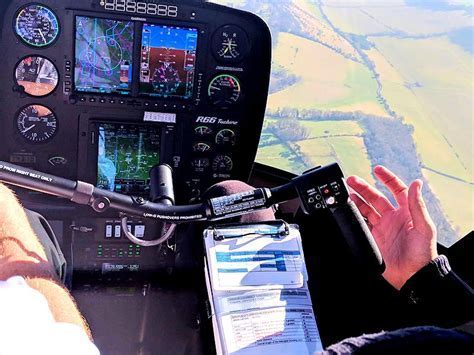 helicopter flight instructor teaching proper cyclic control to new pilot in simulator