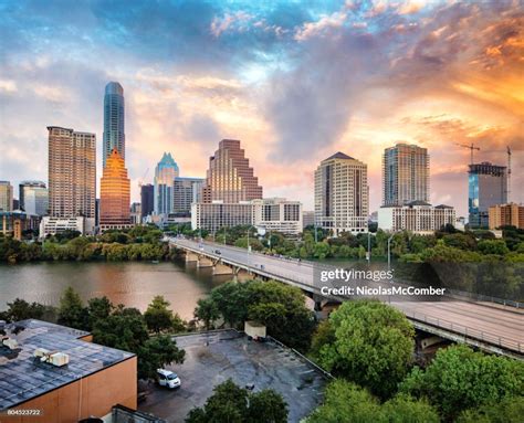 helicopter flying above downtown Austin skyline at sunset