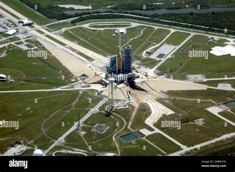 helicopter flying over Kennedy Space Center with rocket launch pads in view