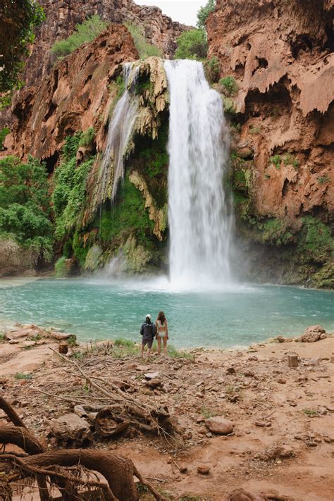 helicopter flying over turquoise Havasupai Falls and canyon cliffs