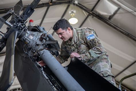 helicopter mechanic undergoing informal field interview at siller base camp