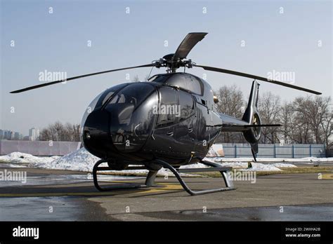 helicopter parked at international heliport with flags and tail numbers from multiple countries