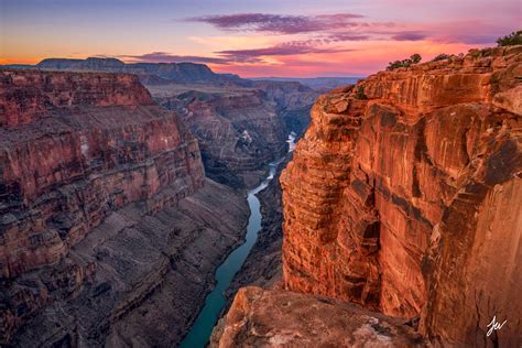 helicopter passengers taking photos over colorado river inside grand canyon