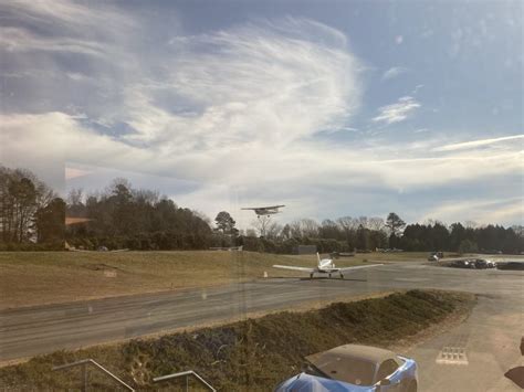 helicopters and small planes parked at Lake Norman Airpark during open house