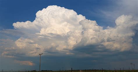 high altitude cumulonimbus cloud tops with aircraft cruising above
