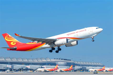 Hong Kong International Airport cargo and passenger aircraft on apron with Pacific backdrop