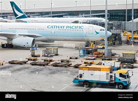 Hong Kong International Airport cargo terminal freighter loading with Cathay Pacific Cargo aircraft on the apron