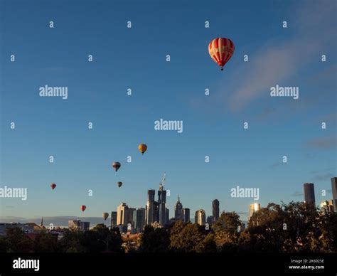 hot air balloon floating above Melbourne Bay at dawn